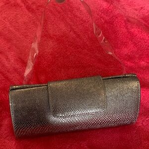 Silver metallic bag with clear strap. Excellent condition, never used.